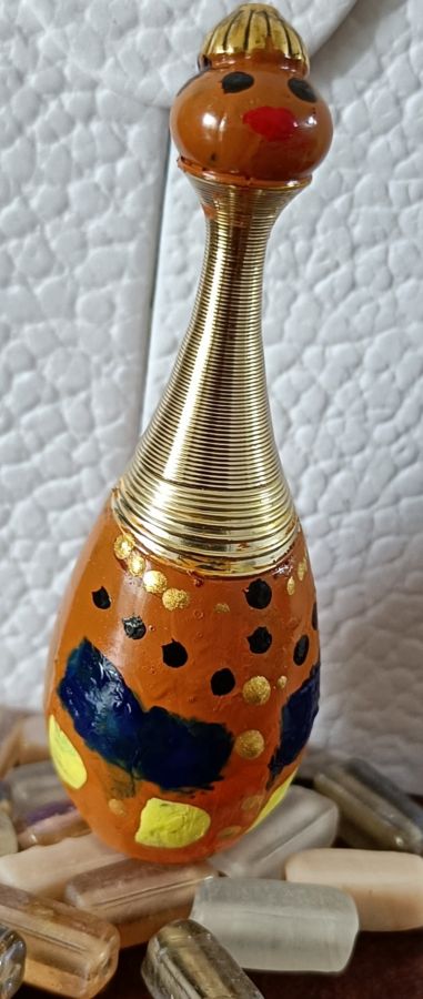 dior bottle painted as tribal woman
