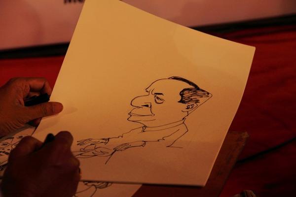 Dr. Bal Murli's Caricature  being drawn by Prabhakar Wairkar.JPG