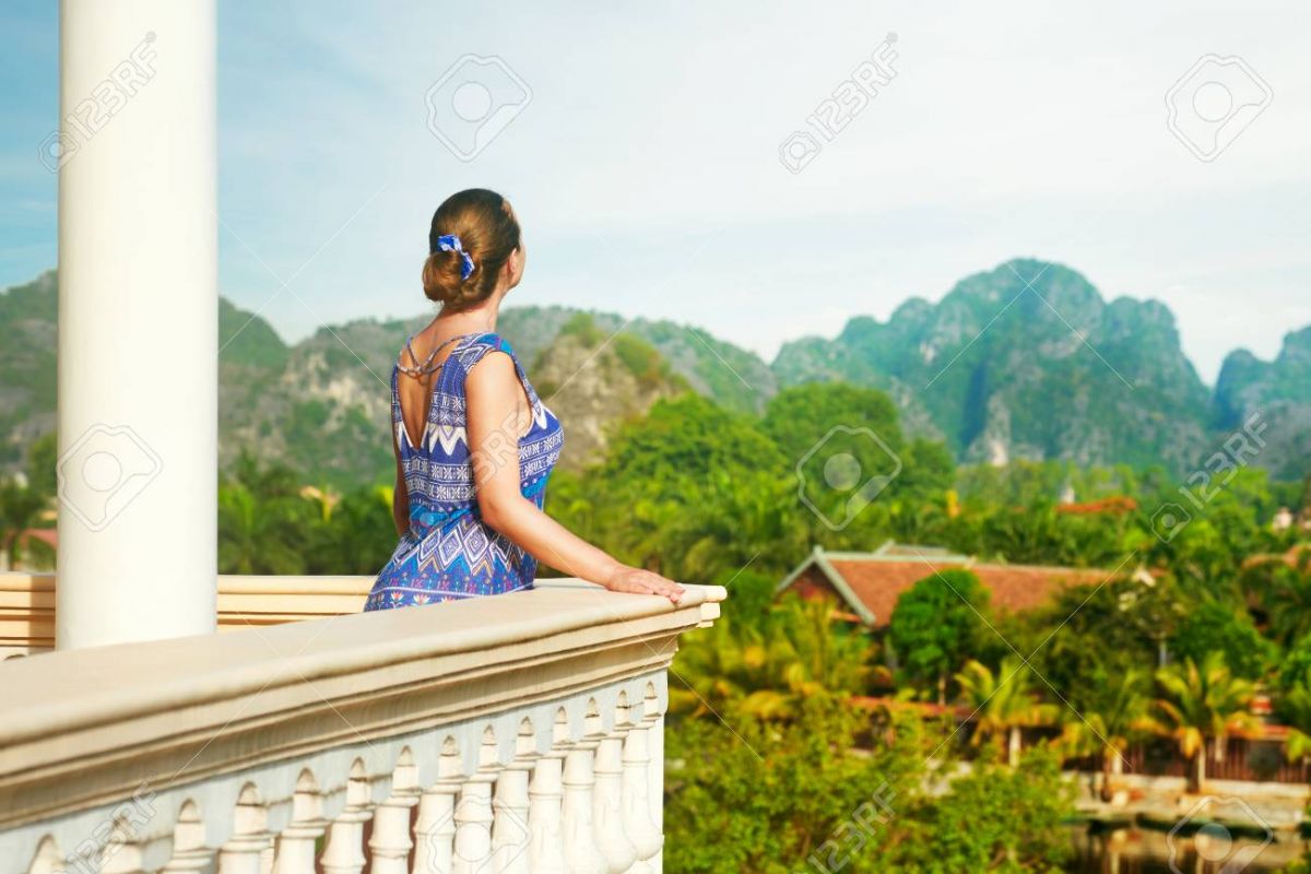 81856447-woman-standing-on-the-balcony-watching-beautiful-mountains-view-travel-and-relaxation-concept-.jpg